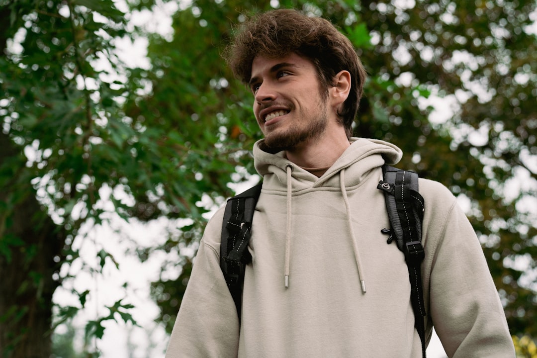 social-feed-img-04 a-man-in-a-hoodie-smiles-at-the-camera-me2lzghtbug